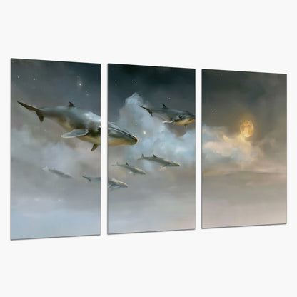 Whales drifting through pale dreamlike clouds toward a golden moon set of 3 poster prints on a white background