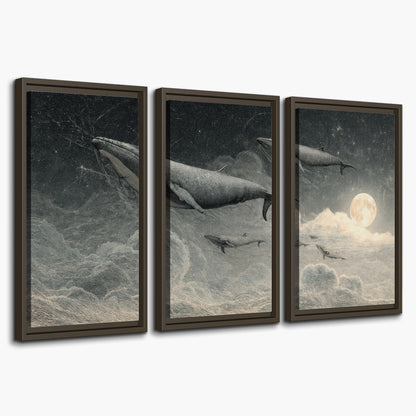Monochrome whales floating over misty clouds beside a luminous painted moon 3 piece framed canvas wall art on a white background