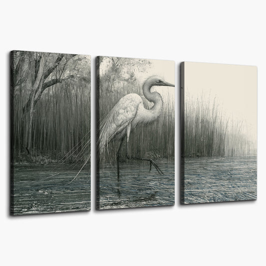 A pale long-legged heron standing beside tall reeds in a muted gray-green wetland 3 piece canvas wall art on a white background