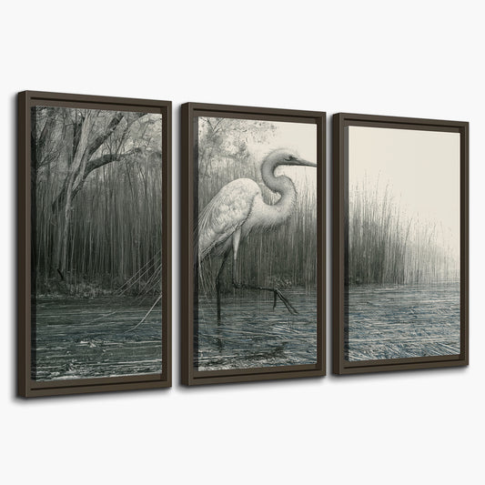 A pale long-legged heron standing beside tall reeds in a muted gray-green wetland 3 piece framed canvas wall art on a white background