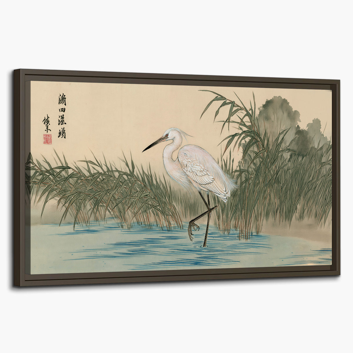 A white heron standing beside a quiet river with reeds and distant hills single framed canvas wall art on a white background