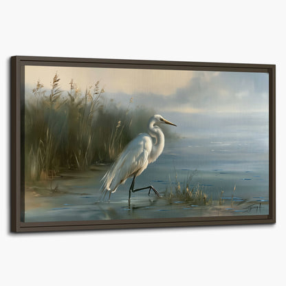 A white heron beside tall marsh grasses and still blue water single framed canvas wall art on a white background