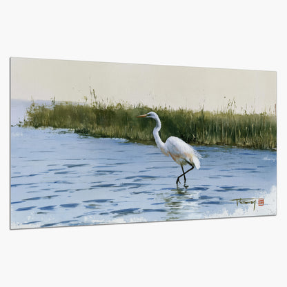 A white heron wading through bright blue water beside green reeds single poster print on a white background