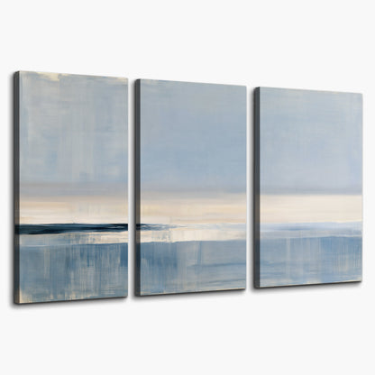 A minimal blue seascape with a pale horizon and soft vertical reflections 3 piece canvas wall art on a white background