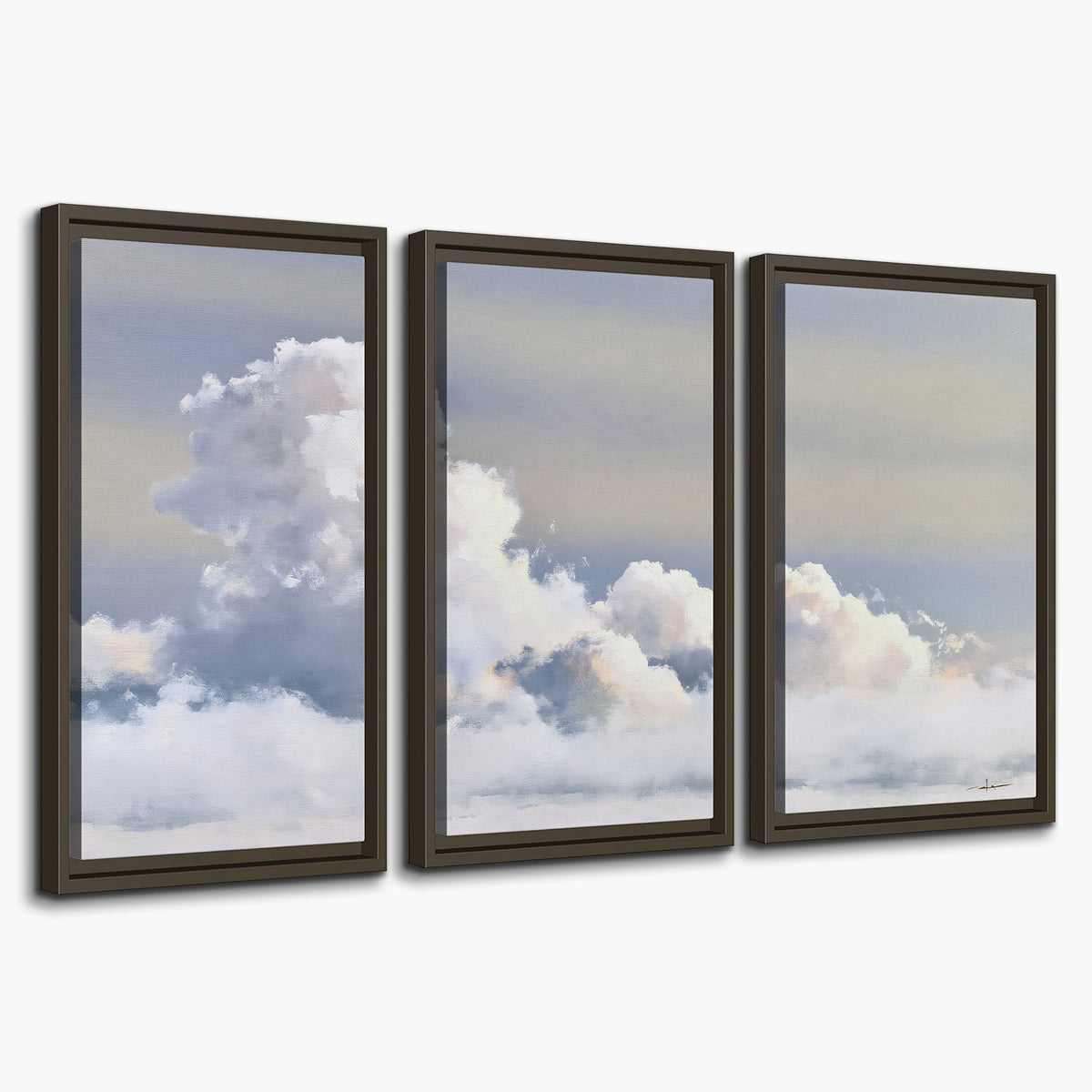 Large white clouds rising through a pale blue sky with gentle warm highlights 3 piece framed canvas wall art on a white background