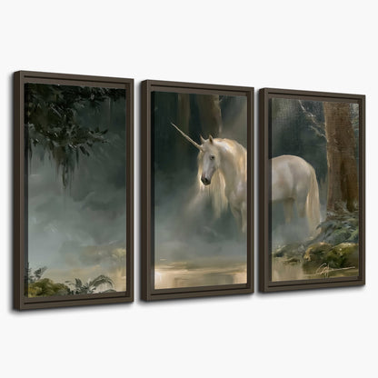 A white unicorn standing near rocks and a quiet stream in a green woodland 3 piece framed canvas wall art on a white background
