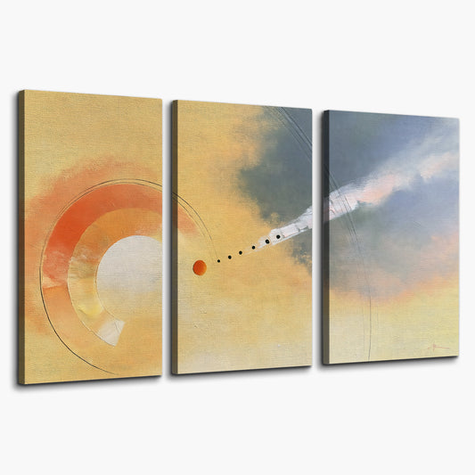 A warm orange circular form and diagonal pale streaks across a muted yellow and blue field 3 piece canvas wall art on a white background