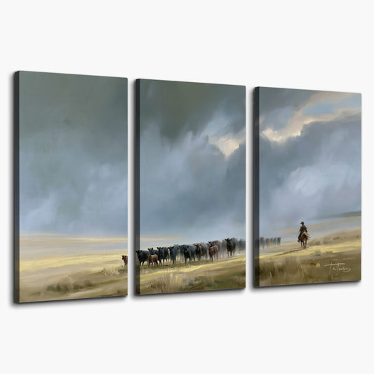 A rider and cattle moving across a sunlit grassland beneath a dramatic blue-gray sky 3 piece canvas wall art on a white background
