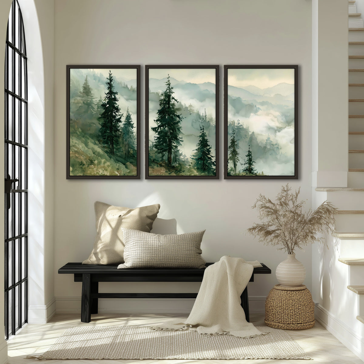 Misty mountain pines watercolor 3 piece framed canvas in an entryway above a bench