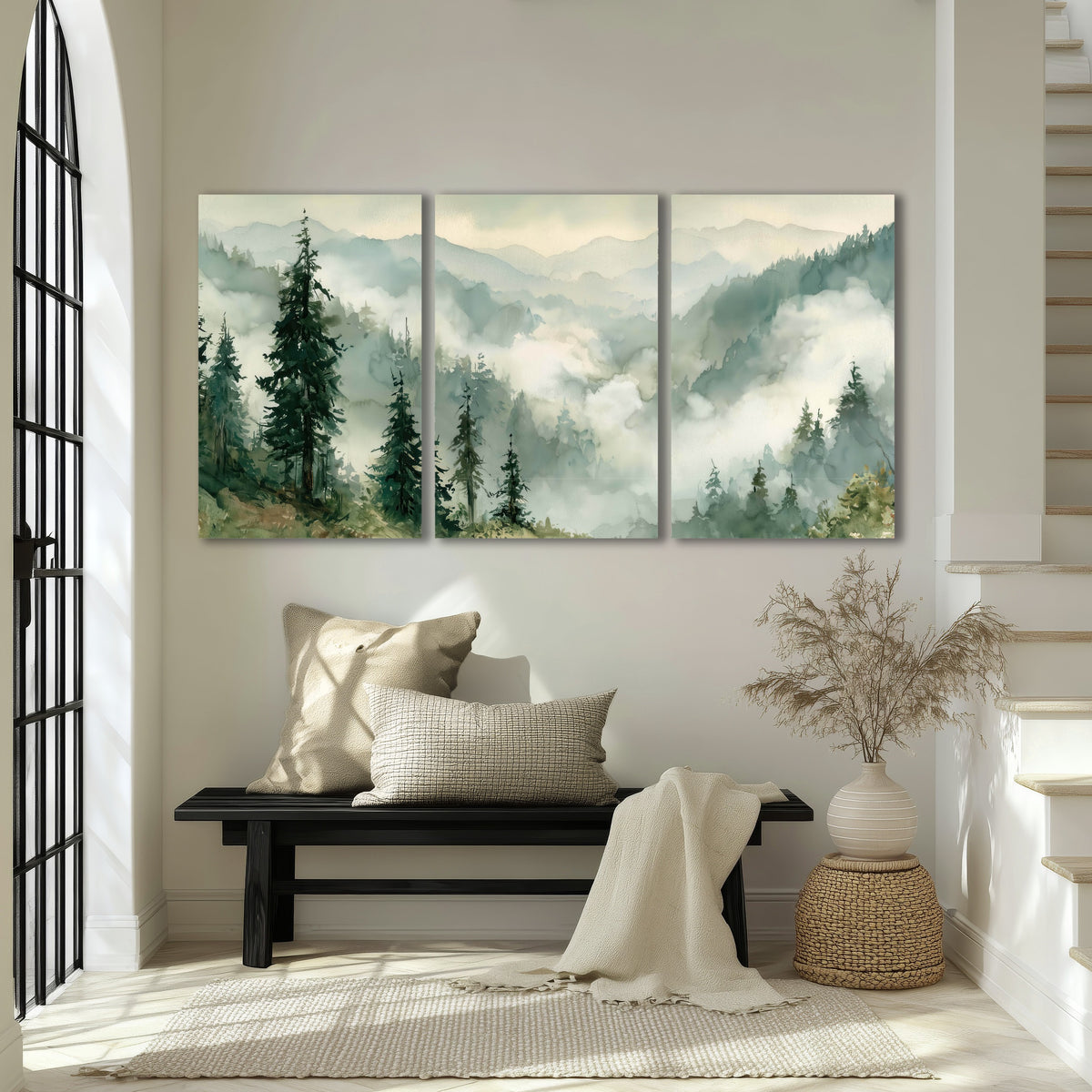 Watercolor misty mountain forest painting 3 piece canvas wall art in an entryway above a bench