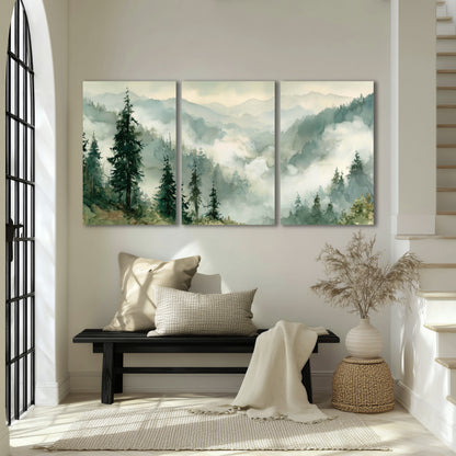 Watercolor misty mountain forest painting 3 piece canvas wall art in an entryway above a bench