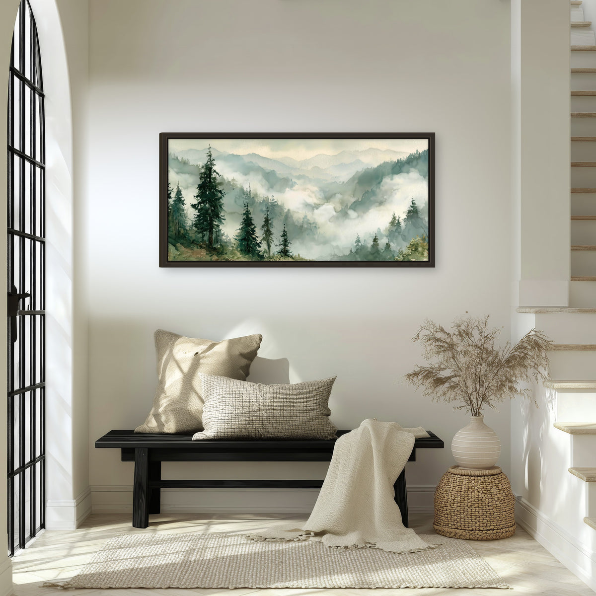 Watercolor misty mountain forest painting framed canvas wall art in an entryway above a bench