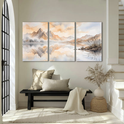 Watercolor mountain lake painting 3 piece canvas wall art in an entryway above a bench