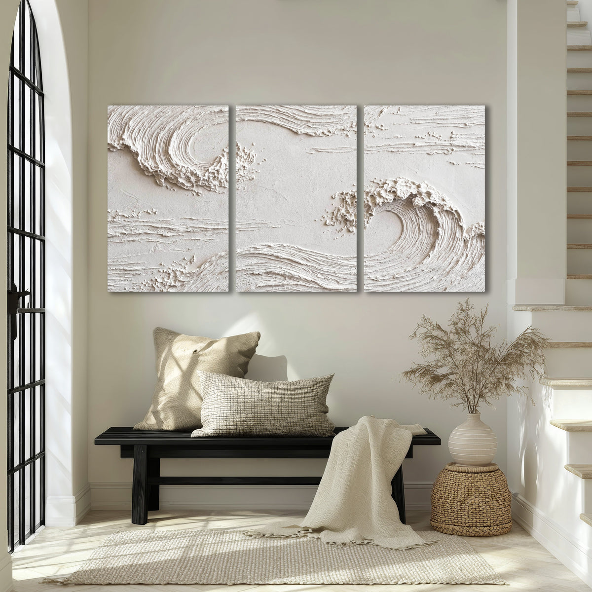 White plaster wave art 3 piece canvas wall art in an entryway above a bench
