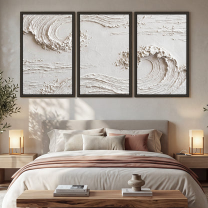 White plaster wave art 3 piece framed canvas in a bedroom above the bed