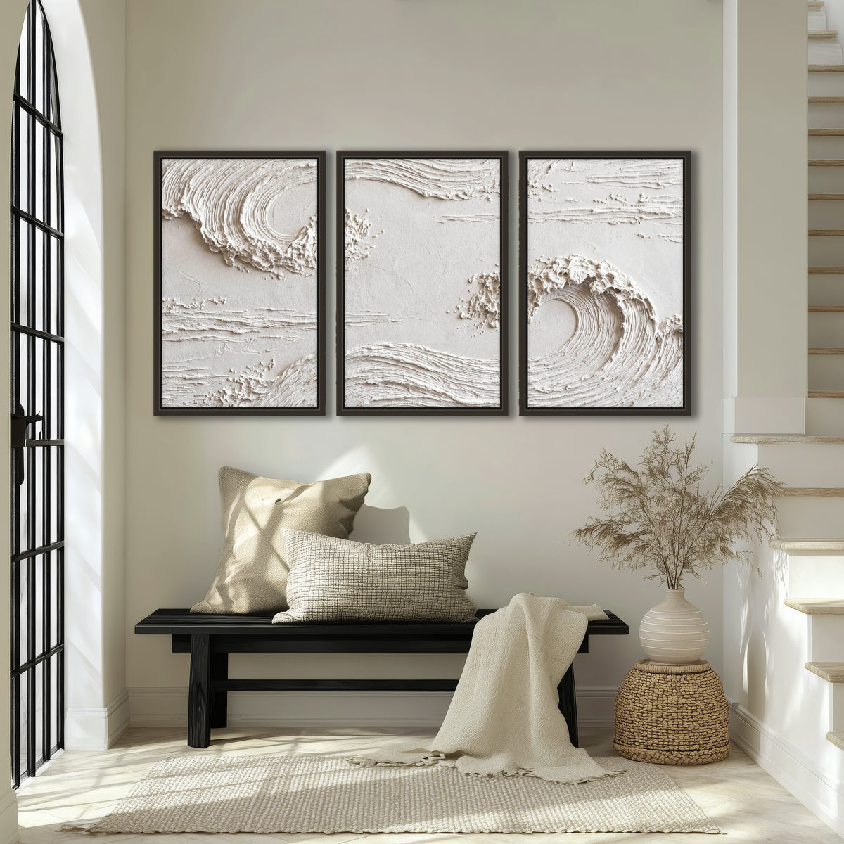 White plaster wave art 3 piece framed canvas in an entryway above a bench