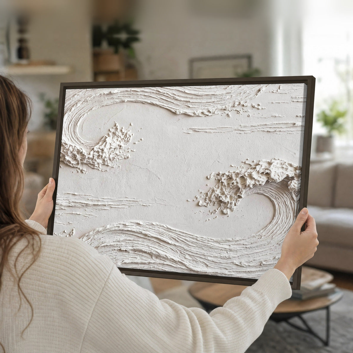 White plaster wave art framed canvas held in hands