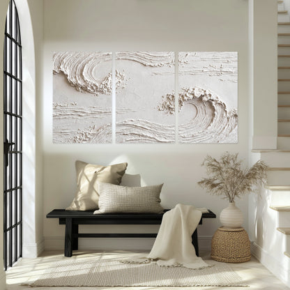 White plaster wave art set of 3 poster prints in an entryway above a bench