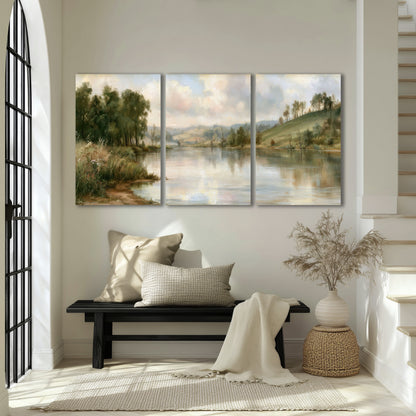 Pastel river valley painting 3 piece canvas wall art in an entryway above a bench