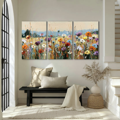 Colorful wildflower meadow painting 3 piece canvas wall art in an entryway above a bench