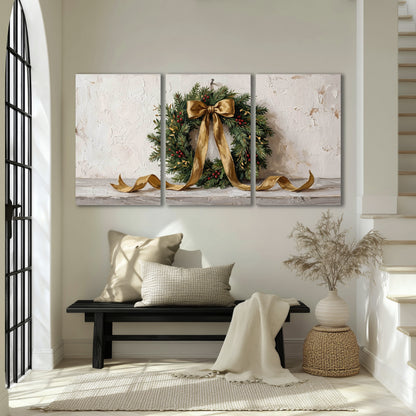 Christmas wreath gold ribbon painting 3 piece canvas wall art in an entryway above a bench