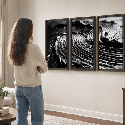 Black and silver swirl abstract painting 3 piece framed canvas in a living room