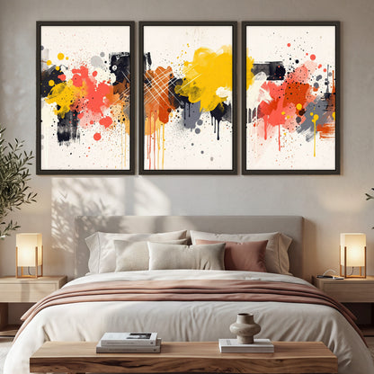 Paint splash abstract painting 3 piece framed canvas in a bedroom above the bed