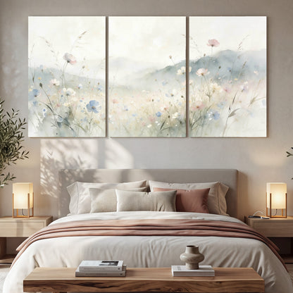 Watercolor wildflower meadow painting 3 piece canvas wall art in a bedroom above the bed
