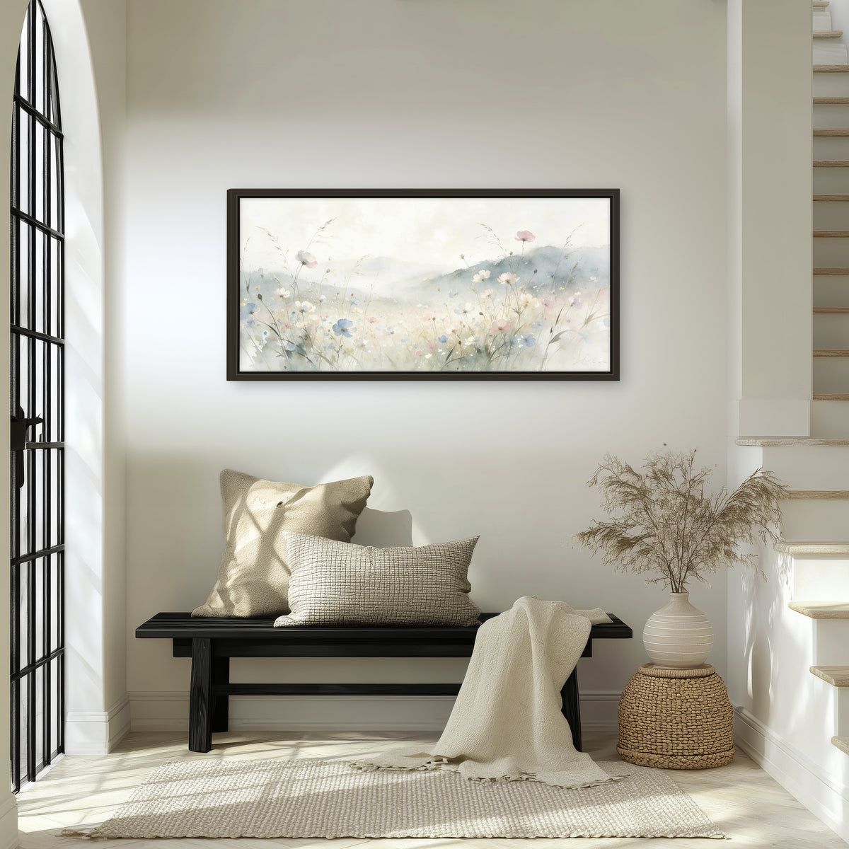 Watercolor wildflower meadow painting framed canvas wall art in an entryway above a bench