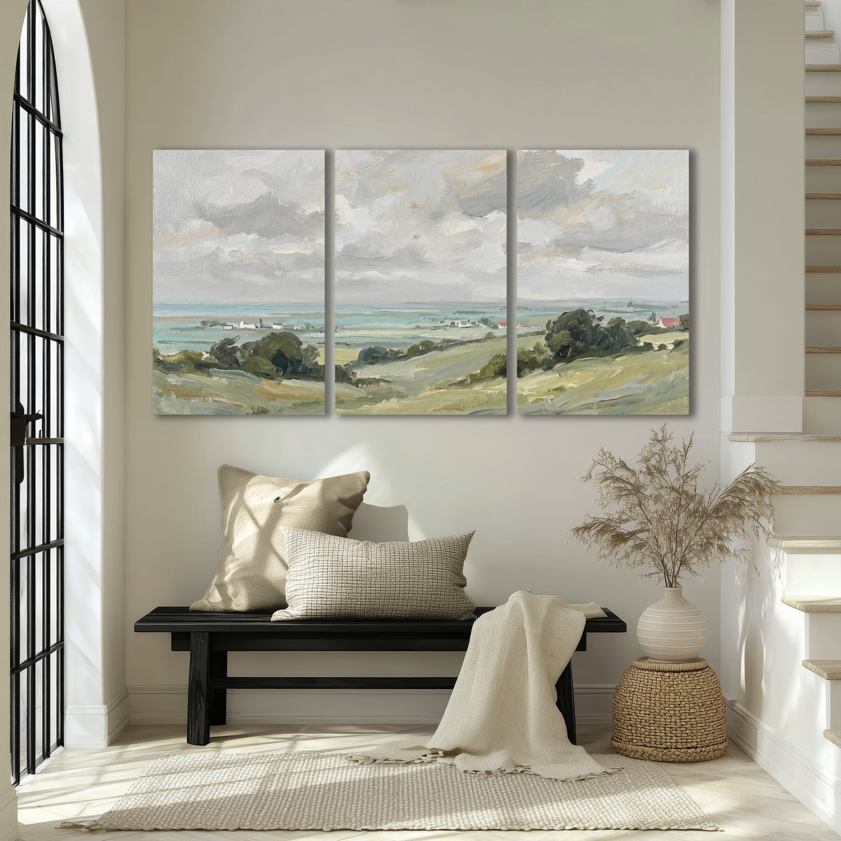 Coastal Countryside 3 piece canvas wall art set hanging in an entryway above a bench
