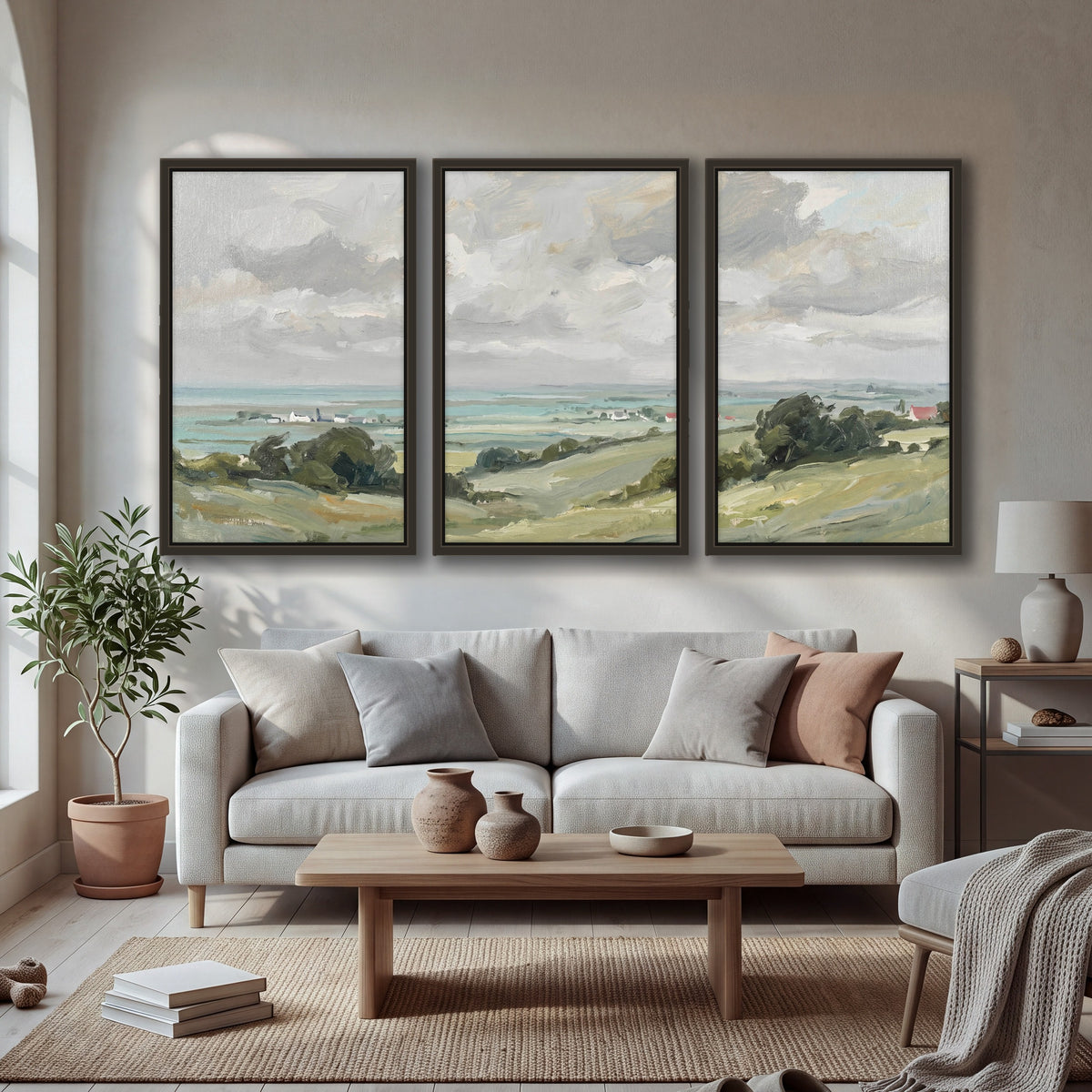 Coastal Countryside 3 piece framed canvas wall art hanging in a bright living room