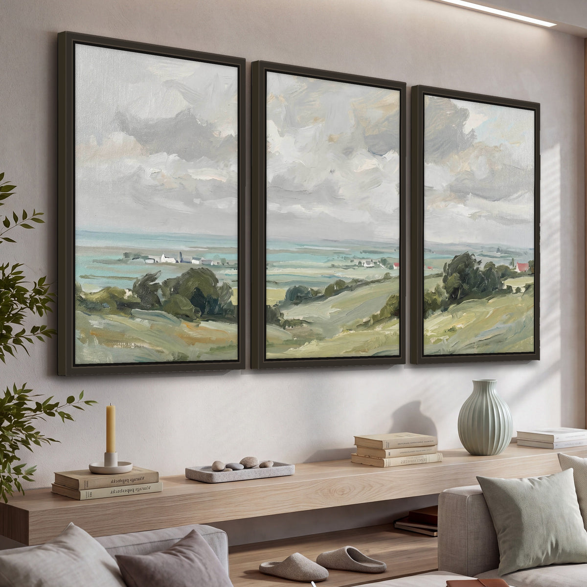 Coastal Countryside 3 piece framed canvas wall art hanging in a living room with a long console