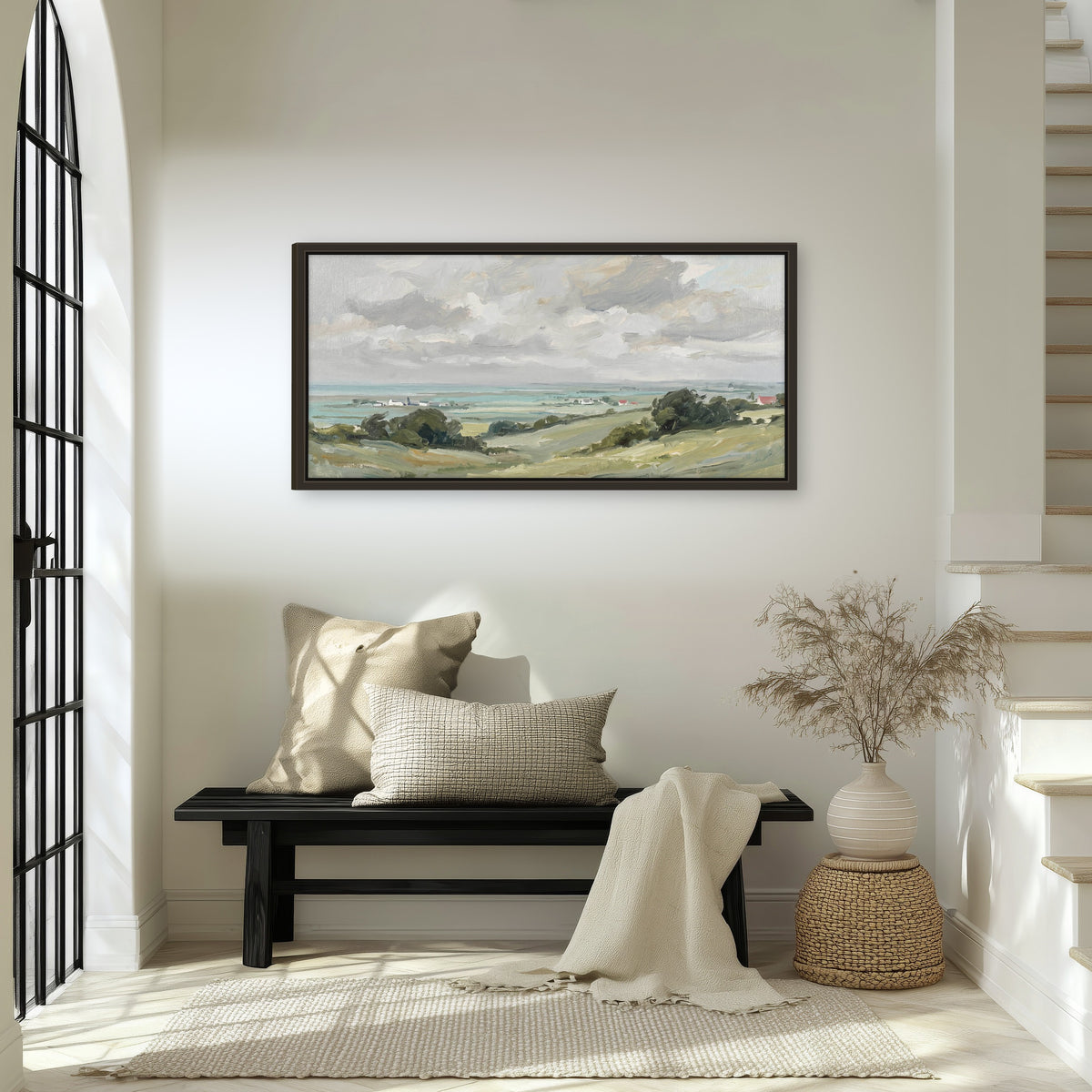 Coastal countryside framed canvas wall art in an entryway above a bench