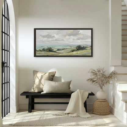 Coastal countryside framed canvas wall art in an entryway above a bench