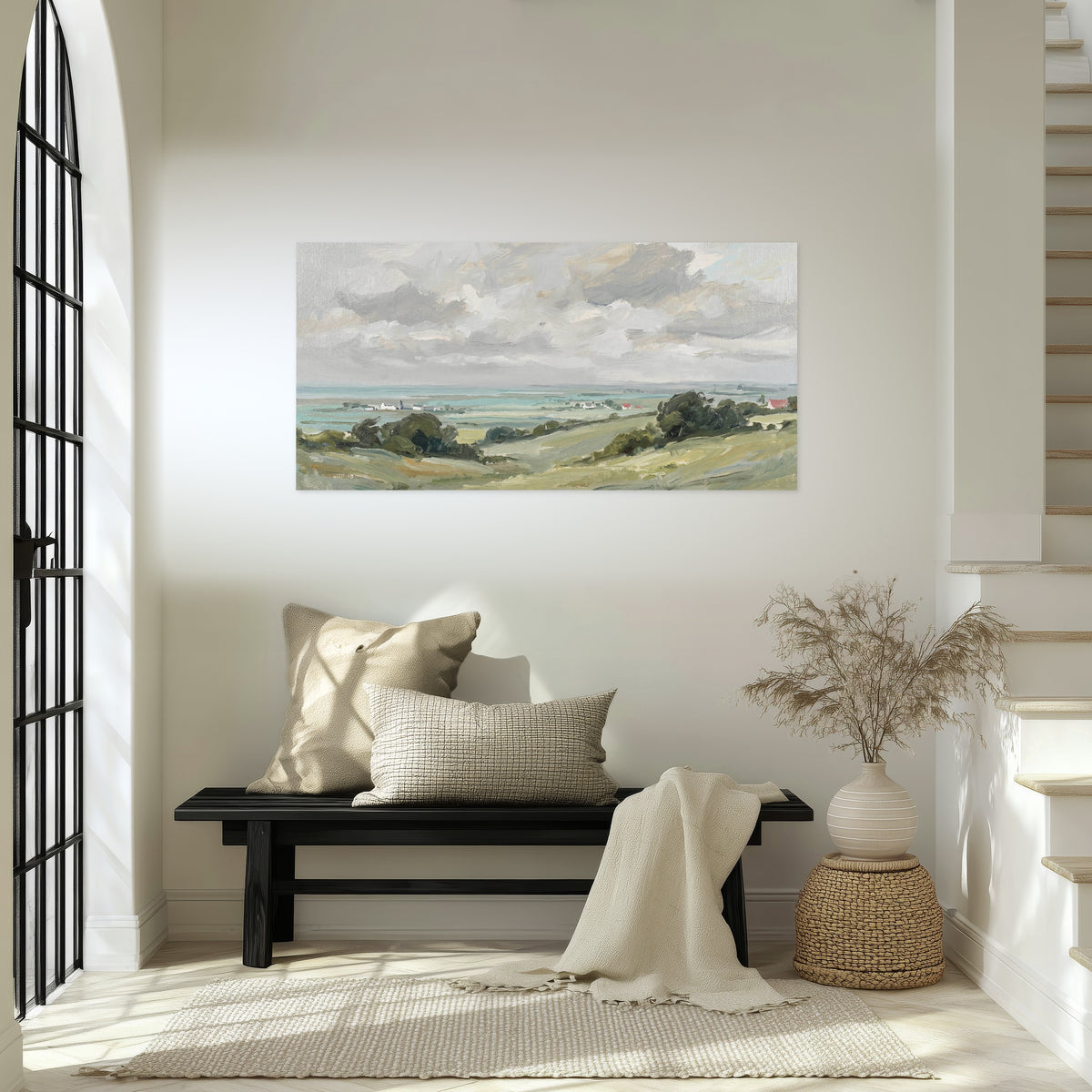 Coastal countryside poster print in an entryway above a bench