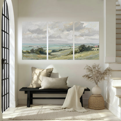 Coastal Countryside set of 3 poster prints hanging in an entryway with a bench