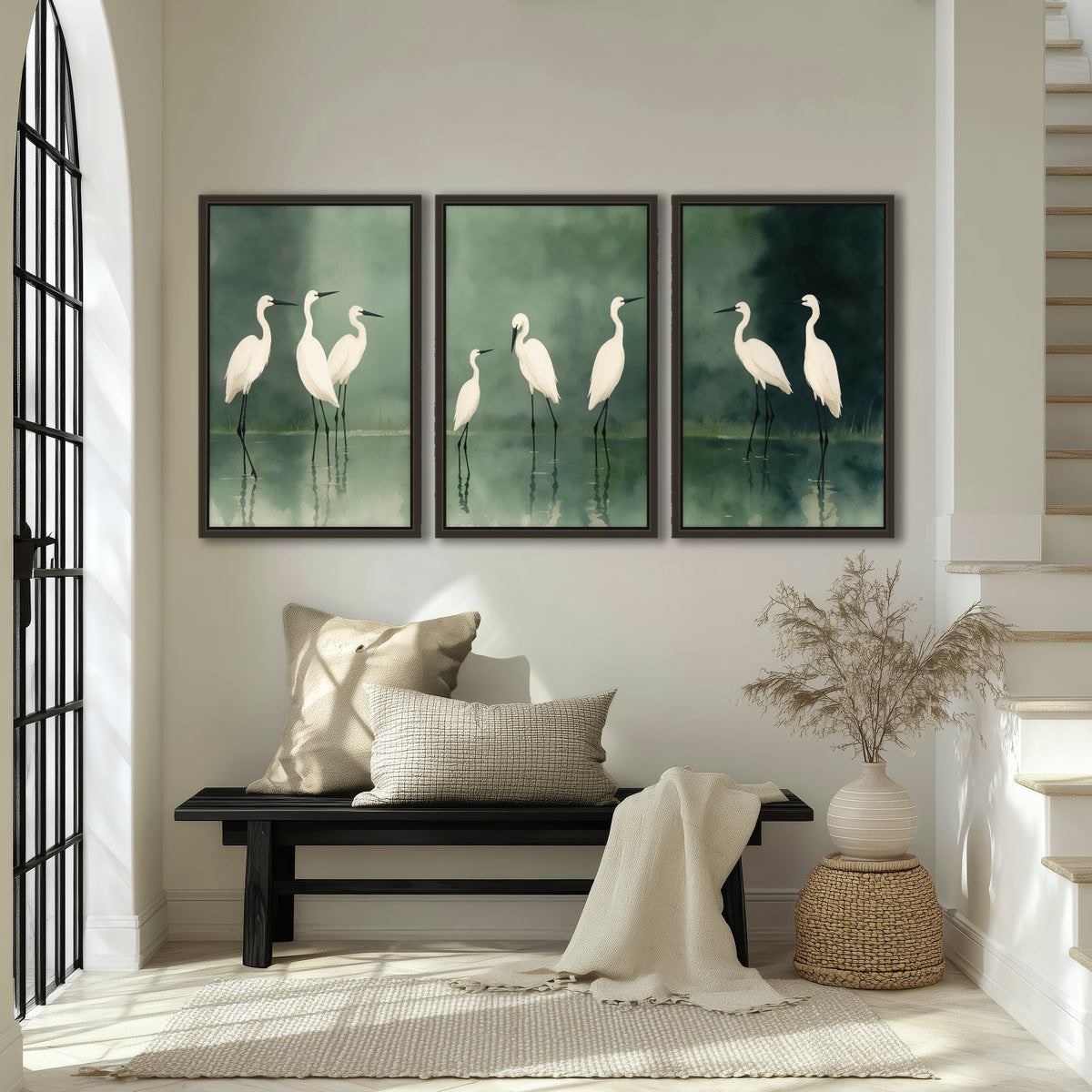 White egrets on green lake painting 3 piece framed canvas in an entryway above a bench