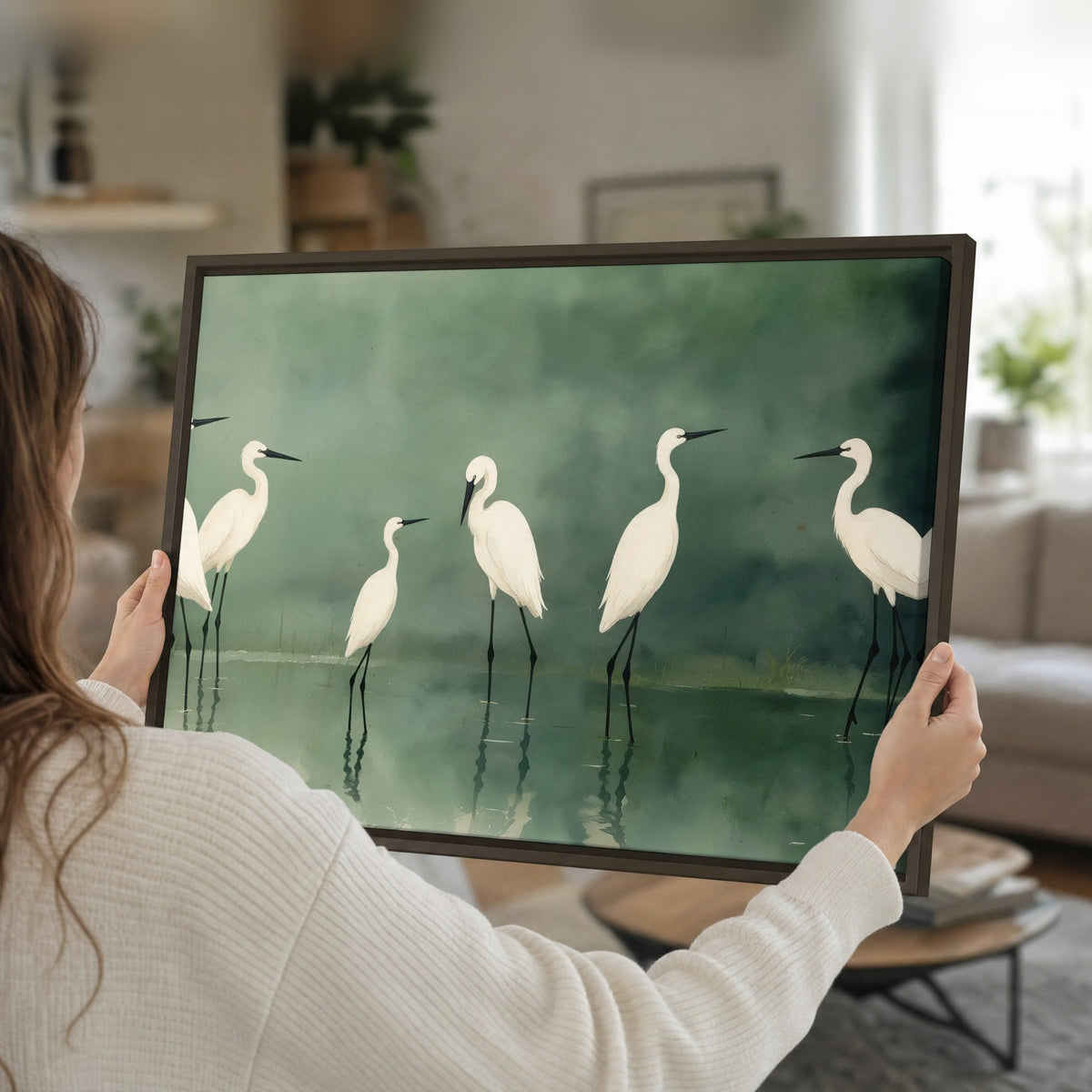 White egrets on green lake painting framed canvas held in hands