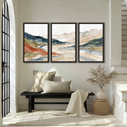 Watercolor mountain valley painting 3 piece framed canvas in an entryway above a bench
