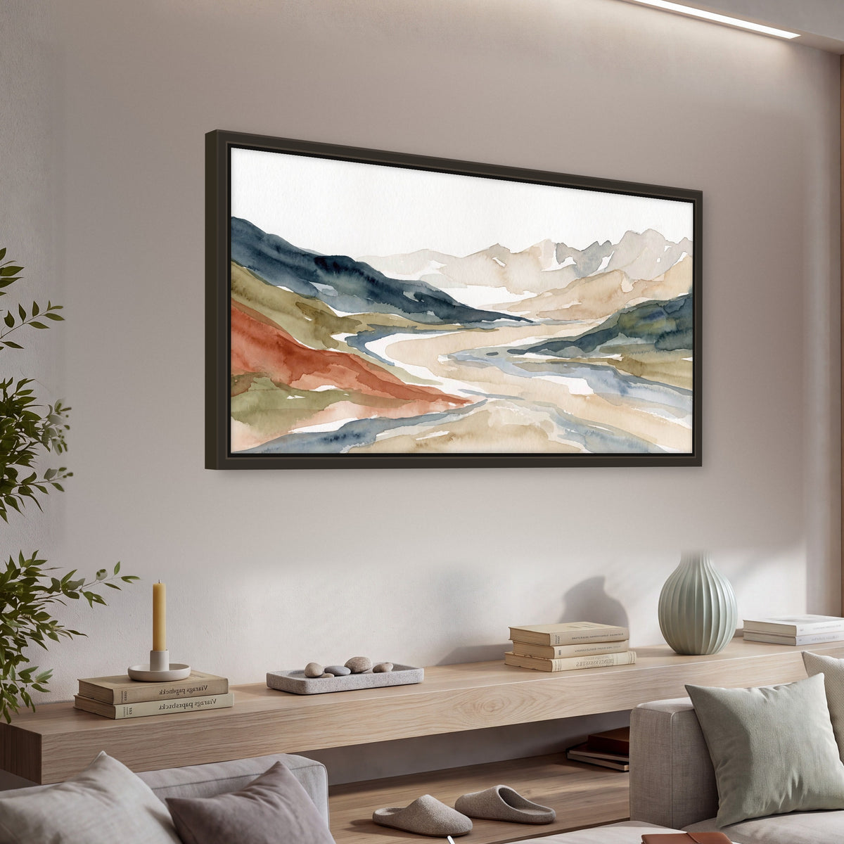 Watercolor mountain valley painting framed canvas wall art in a living room above a console