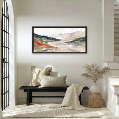 Watercolor mountain valley painting framed canvas wall art in an entryway above a bench