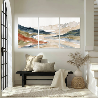 Watercolor mountain valley painting set of 3 poster prints in an entryway above a bench