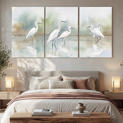 White egrets watercolor 3 piece canvas wall art in a bedroom above the bed