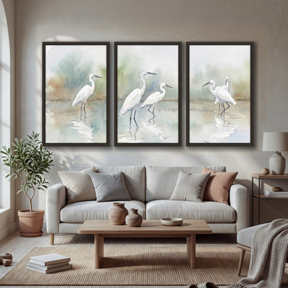 White egrets watercolor 3 piece framed canvas in a bright living room