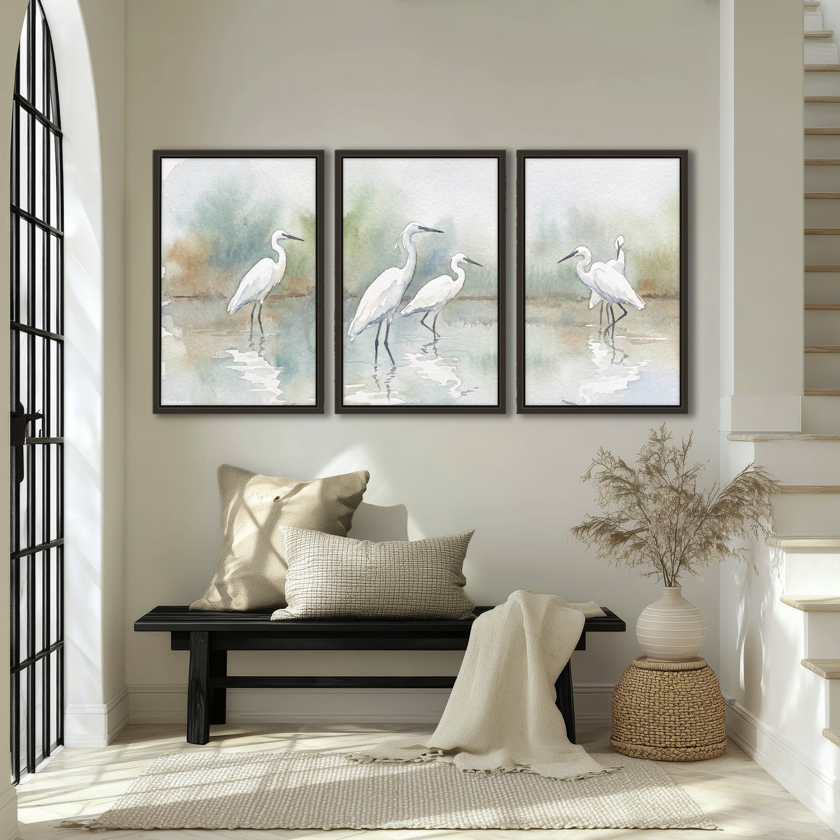 White egrets watercolor 3 piece framed canvas in an entryway above a bench