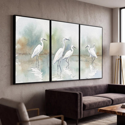 White egrets watercolor 3 piece framed canvas in a modern living room