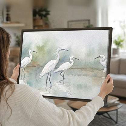 White egrets watercolor framed canvas held in hands