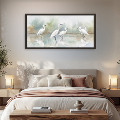 White egrets watercolor framed canvas wall art in a bedroom above the bed