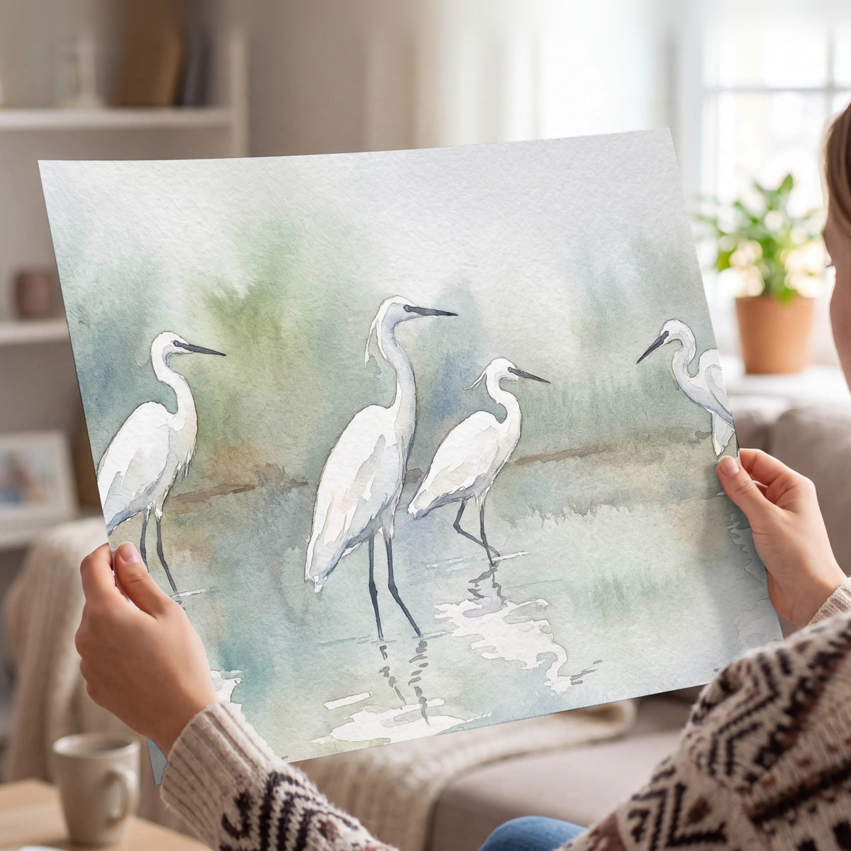 White egrets watercolor poster print held in hands