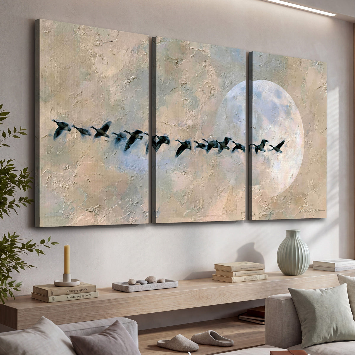 Geese flying across the moon painting 3 piece canvas wall art in a living room above a console